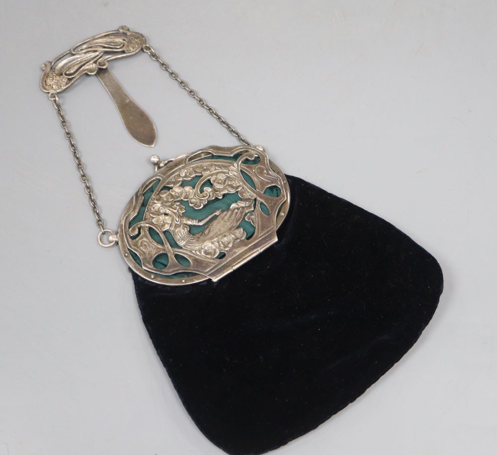 A late Victorian Art Nouveau silver mounted velvet evening purse, with suspension clip and chain,
